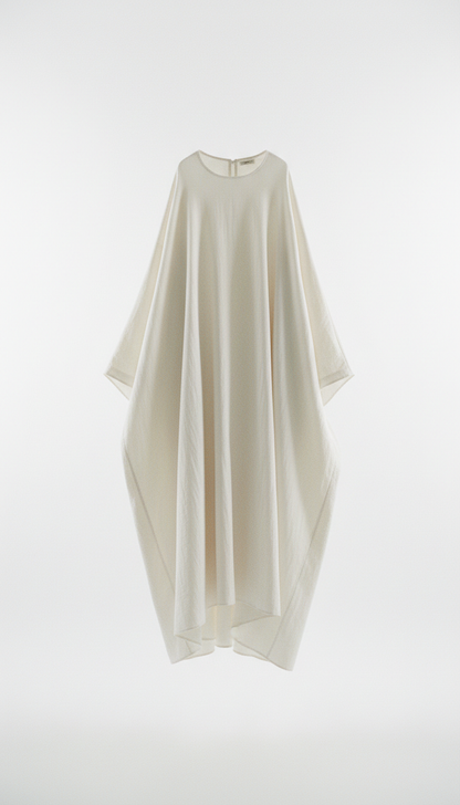 An oversized cotton dress from Modern Simplicity, with soft, shadowless illumination. The image maintains a modern and...