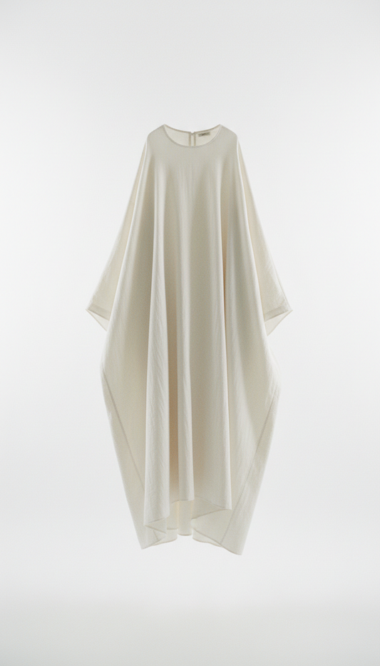 An oversized cotton dress from Modern Simplicity, with soft, shadowless illumination. The image maintains a modern and...