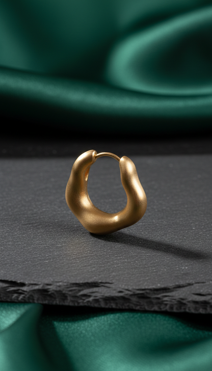 Brushed gold sculptural hoop earrings in a new setting