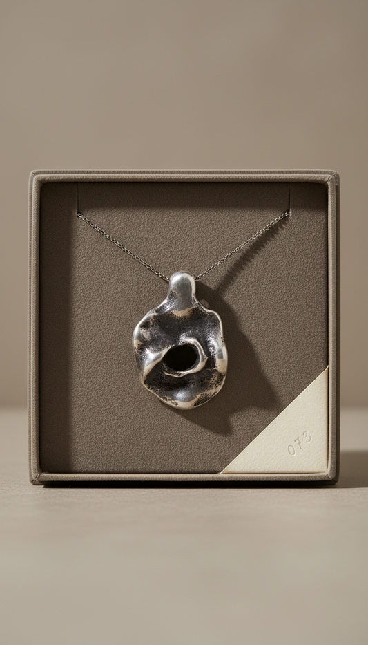 Pendant necklace in burnished silver finish, Default: Pendant centered or elegantly off-center at 3/4 angle (not flat lay),...